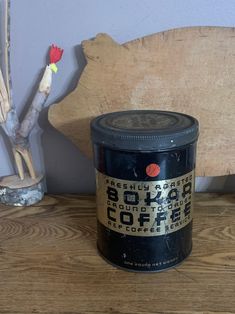 an old tin can sitting on top of a wooden table