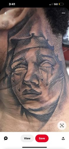 a man with a tattoo on his chest has a face drawn in the shape of a woman's head