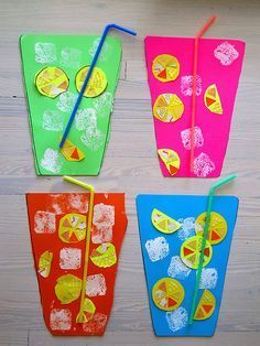 four different colored papers with straws and lemon slices on them