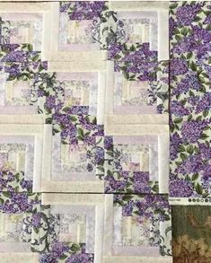 purple and white quilt with flowers on it