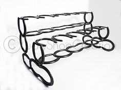 a metal rack with several pairs of glasses on it's sides and two rows of oval holes in the middle