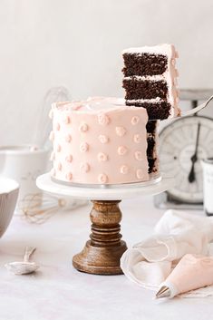 two pieces of cake sitting on top of a table next to other desserts and utensils