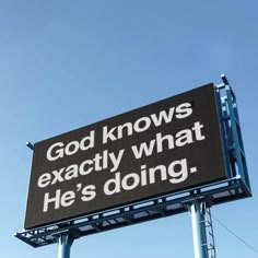 a large sign that says god knows exactly what he's doing