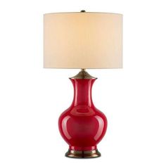 a red lamp with a white shade on it