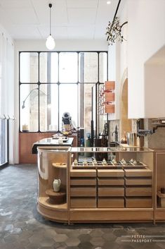 an empty kitchen with lots of counter space and large windows in the back ground area