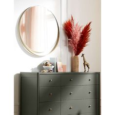 a dresser with drawers and a mirror above it