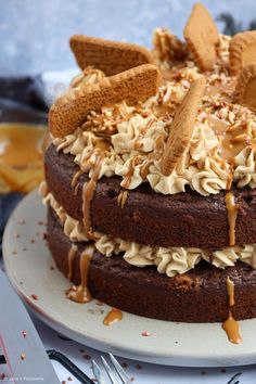 a chocolate cake topped with whipped cream and caramel drizzled on top