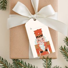 a present wrapped in brown paper with a white ribbon and tag attached to the top