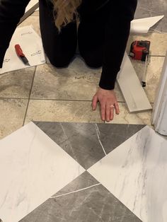 a woman is laying on the floor with her hands in front of an object that looks like a diamond