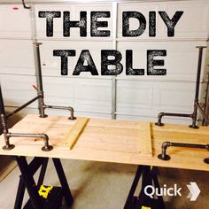 the diy table is made out of wood and metal pipe holders with words over it