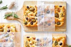 four different types of food wrapped in cellophane and tied together on cutting boards