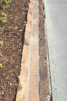 a red fire hydrant sitting on the side of a road next to a sidewalk