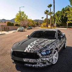 a black and white car parked on the street