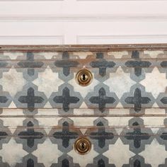 an old dresser has been painted with black and white geometric designs on it's drawers