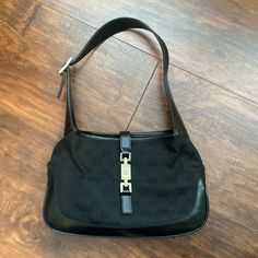 Used Vintage Jackie O Hobo In Black Gg (Cloth W/Black Leather Trim). Bag Was Purchased In 2001, Brand New. It Is Used But In Good, Wearable Condition. Buckle Does Have Some Discoloration. Comes With Dust Bag And Two Tags Shown In Pictures (However, Not Original Dustbag. This Dustbag Is A Bit Small For Bag). Gucci Hobo Bag Vintage, Gucci Jackie Bag Vintage, Brown Gucci Bag, Jackie O, Trim Color, Gucci Black, Gucci Bags, Leather Trim, Gucci Jackie Bag