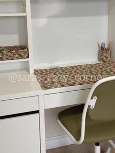 a white desk with a chair and some bookshelves on top of it in a room