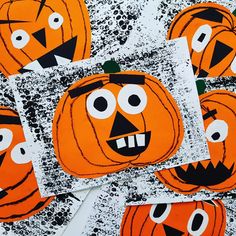 several pumpkins with faces drawn on them