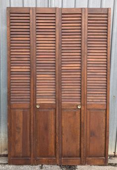 three wooden doors with shutters on each side