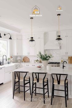 a kitchen with white cabinets and black chairs