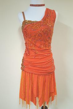 an orange dress with fringes and beads on it