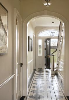 the hallway is clean and ready to be used as an entrance way for someone's home