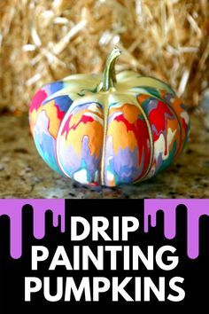 a small painted pumpkin sitting on top of a counter next to dry grass with the words drip painting pumpkins