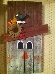 a wooden door with a scarecrow and sunflowers on it