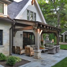 an outdoor living area with furniture and landscaping