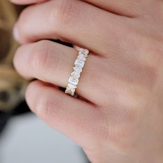 a woman's hand with a diamond ring on it