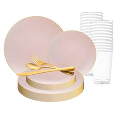 a set of pink and gold dinnerware with plates, cups and utensils