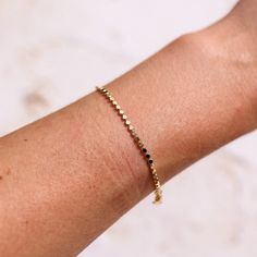 This bracelet is gold filled and will not tarnish, it is the perfect staple piece. It is 6 inches plus a 1 inch extender. Gold Bracelets With 8mm Beads For Beach, Classic Adjustable 14k Gold-filled Bracelets, Minimalist Gold Stretch Bracelet, Hypoallergenic, Dainty 14k Gold-filled Stretch Bracelet, Classic Hypoallergenic 14k Gold-filled Bracelet, Staple Pieces, 6 Inches, 1 Inch, Gold Filled