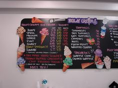 two large chalk boards with different types of ice creams on them, hanging from the wall