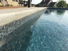 an empty swimming pool with clear blue water