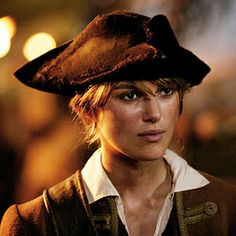 a woman wearing a pirate hat in the dark