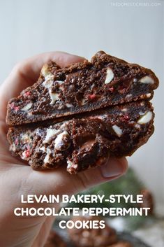 a person holding up a chocolate peppermint cookie with the words levi bakery - style chocolate peppermint cookies