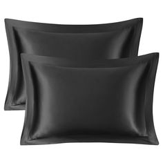 two black pillows and one pillow case