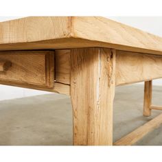 a wooden table with two drawers underneath it