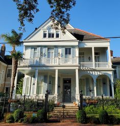 a large white house with lots of windows and balconies