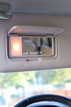 the interior of a car with an image of a light on it's side mirror