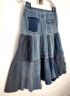 a denim skirt hanging on a wall