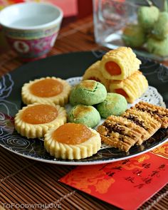 a plate full of cookies and pastries on a table