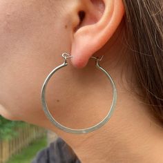 Brushed metal and a flattened, flowing edge form this classic hoop earring. Features nickel- and lead-free earring wires. Handmade by women artisans in India. Earring Wires, Free Earrings, Brushed Metal, Women Artisans, Silver Hoops, Scarf Accessory, Hoop Earrings, India, Silver