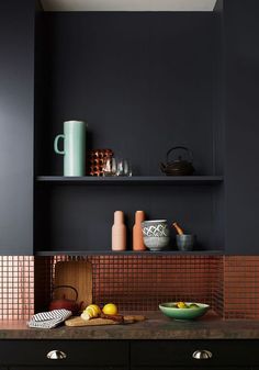 an image of a kitchen with black walls and tile backsplashes on the wall