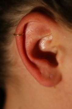 a close up of a person's ear with an object in the middle