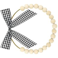 a black and white checkered bow tie on a beaded bracelet with a ribbon