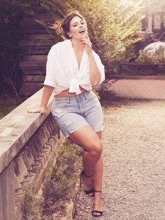 a woman leaning on a wall and laughing