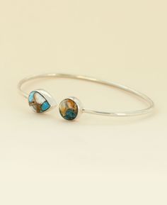 Nature meets elegance in this sterling silver adjustable open-ended bracelet designed with two turquoise spiny oyster stones, one round and the other teardrop shaped. This captivating bracelet effortlessly captures the unique fusion of land and sea. Each stone is unique in textures and colors making yours one of a kind. Made of sterling silver Perfect Fit: The bracelet's circumference is approximately 7.5" and is suitable for wrist sizes 6.5 - 8 inches, ensuring a comfortable and secure fit for Adjustable Southwestern Teardrop Jewelry, Southwestern Adjustable Teardrop Jewelry, Adjustable Turquoise Teardrop Jewelry, Adjustable Teardrop Jewelry With Polished Finish, Meditation Beads Mala, Lotus Necklace, Land And Sea, Malachite Jewelry, Mala Bracelet