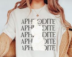 a woman wearing a t - shirt with the words aphrodite on it