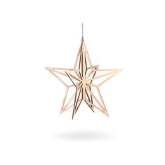 a wooden star ornament hanging from a string on a white background with clippings