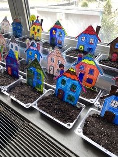 there are many small houses that have been planted in the window sill for sale